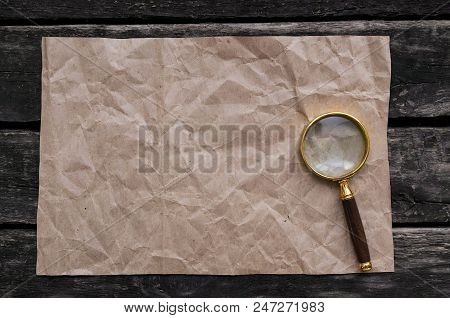 Blank Crumpled Paper Page And Magnifying Glass.  Seaching, Discovering, Revealing And Exploring Conc