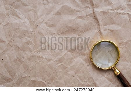 Blank Crumpled Paper Page And Magnifying Glass.  Seaching, Discovering, Revealing And Exploring Conc