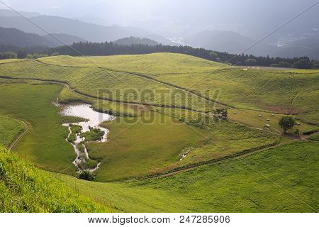 Looking Down On Small Lake In Green Grassland From Top Of Soni Kogen