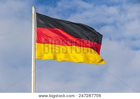 Flag Of Federal Republic Of Germany Waving On The Wind On The Top Of German Parliament Building (bun