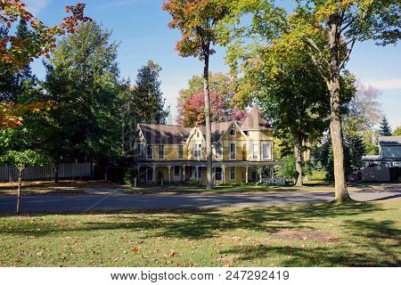 Bay View, Michigan / United States - October 17, 2017: A Large Yellow Victorian Cottage With A Wrapa