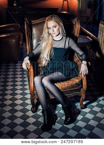 Portrait Of A Blue-eyed Blonde In Black Clothes. Beautiful Girl Looking At The Camera. Woman With Lo