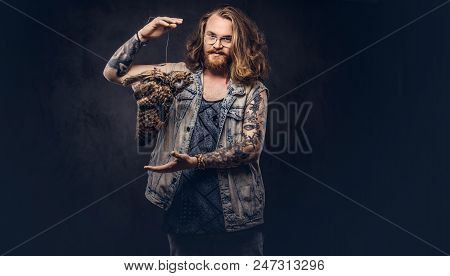 Portrait Of A Tattoed Redhead Hipster Male With Long Luxuriant Hair And Full Beard Dressed In A T-sh