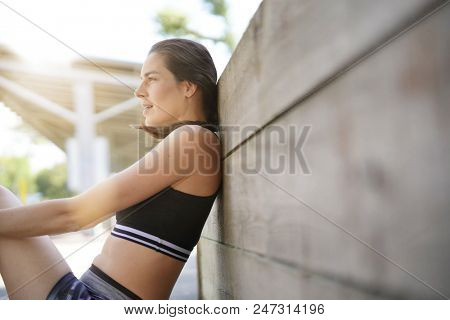 Fitness girl relaxing after exerciing