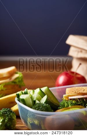 Tasty Lunch With Green Lettuce And Fresh Vegetables And Apple In Transparent Plastic Container And D