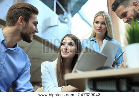 Group Of Young Modern People In Smart Casual Wear Having A Brainstorm Meeting While Standing In The 