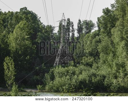 High Voltage Post At Summer Forest. Green Forest. Urban. Steel Tower Of High Voltage Electric Transm