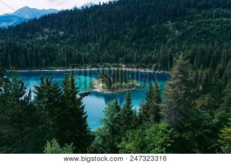 Caumasee Lake With A Small Island Located In The Middle Of The Crystal Clean Lake, Near Flims, Switz