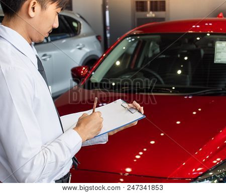 This Career Man Saleman Business Inspection Writing On Notepad Or Book, Paper With Car Blurry Backgr