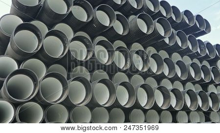 Warehouse Of Finished Plastic Pipes Industrial Outdoors Storage Site. Manufacture Of Plastic Water P