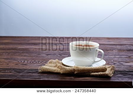 Looking Down On A Cup Of Tea Hot Beverage With Cinnamom, Mint Leaves And Fruits Of Star Anise.