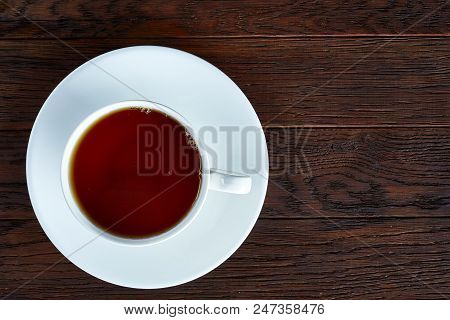 Looking Down On A Cup Of Tea Hot Beverage With Cinnamom, Mint Leaves And Fruits Of Star Anise.