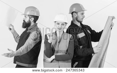 Inspector Disappointed About Employee, Builder. Men And Woman In Helmets Carefree With Hammer And Pr