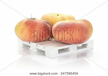 Three Fresh Ripe Saturn Peaches On A Wooden Pallet Isolated On White Background