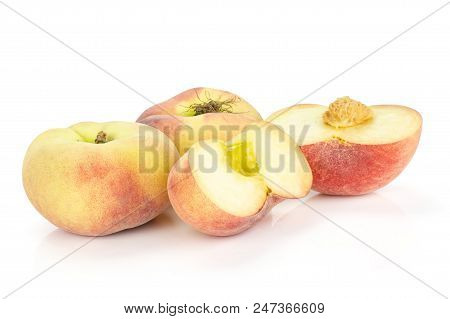 Two Fresh Ripe Saturn Peaches And Two Sliced Halves Isolated On White Background