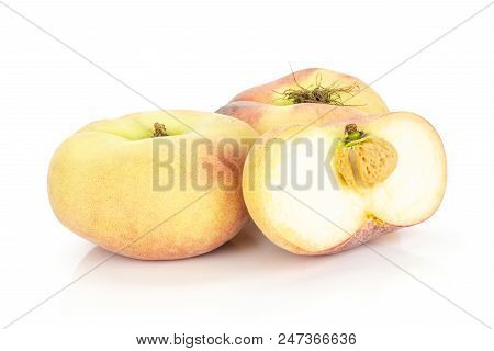 Two Fresh Ripe Saturn Peaches With One Sliced Half Isolated On White Background