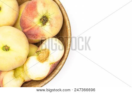 Fresh Ripe Saturn Peaches In A Wooden Bowl Top View Isolated On White Background