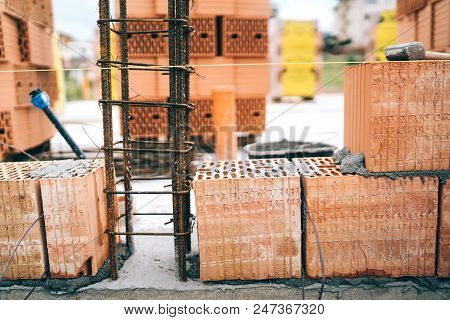 Details Of House Building, Brick Walls And Steel Infrastruture. Construction Site