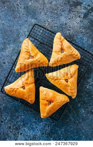 Homemade Uchpuchmak Samsa With Meat And Potato Served On A Wire Rack On A Blue Stone Background. Top