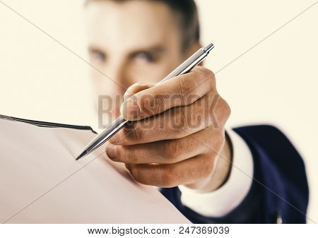 Businessman Holds Pen Near Paper Document, Close Up. Businessman Signs Document By Pen On White Back