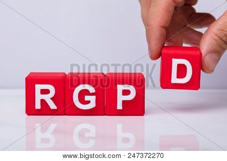 Close-up Of A Human Hand Placing D Letter Red Block To Make Rgpd Word
