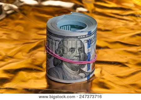 Convolving Notes One Hundred Us Dollars On A Bright Gold Background.