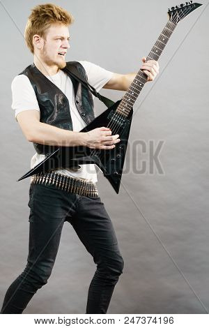 Teen Hardcore Man Wearing Metal Outfit Playing On Electric Guitar Heavy Rock Music Having Yelling Sc Teen Hardcore Man Wearing Metal Outfit Playing On Electric Guitar Heavy Rock Music Having Yelling Sc