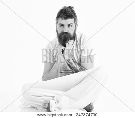 Hangover Morning Concept. Man With Pensive Face Wake Up, Sits, Scratching Beard With Hands. Man Tire