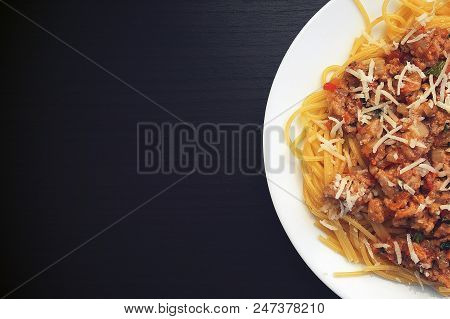 Appetizing Spaghetti In A Plate With Bolognese Sauce On A Dark Background Close Up And Copy Space