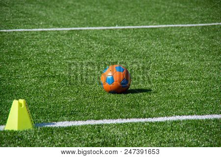 A Orange- Nlue Ball At Green Grass