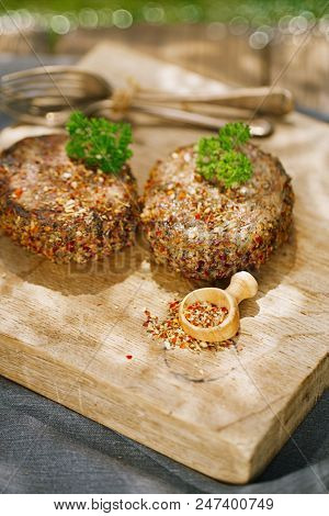lamb burgers spiced by mint and lamb rub on wooded board