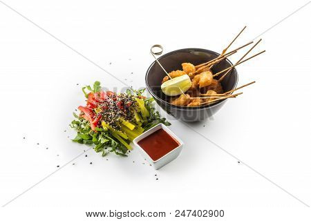 Fried Samon Pieces With Sauce And Vegetable Salad Isolated On White Background.