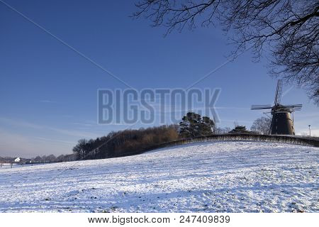 Windmill On The Vrouweheide Near The Limburg Ubachsberg In A Snowy Landscape