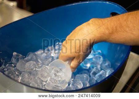 The Barman Is Filling The Glass With Ice.