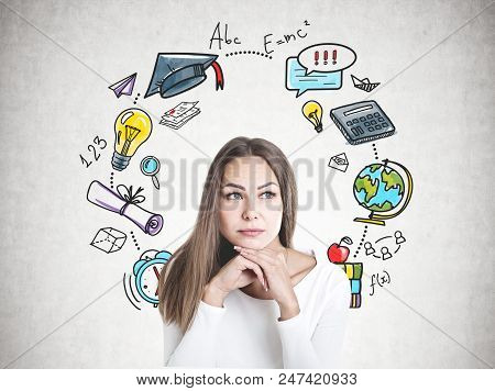Head And Shoulders Portrait Of A Beautiful Young Woman With Fair Hair Wearing White And Thinking Loo