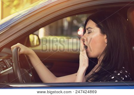 Sleepy Yawning Exhausted Young Woman Driving Her Car After Long Hour Trip. Transportation Sleep Depr