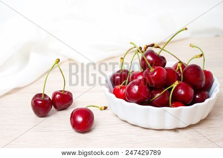 Healthy Eating And Food Concept - Cherries In White Bowl. Cherry On White Background.