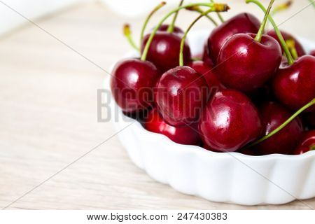 Healthy Eating And Food Concept - Cherries In White Bowl. Cherry On White Background.