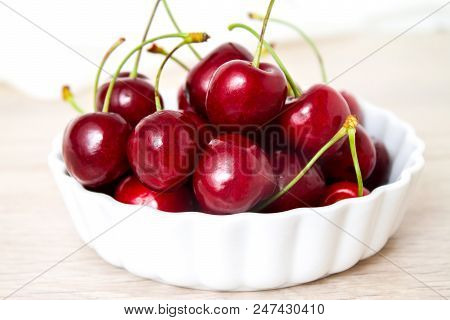 Healthy Eating And Food Concept - Cherries In White Bowl. Cherry On White Background.