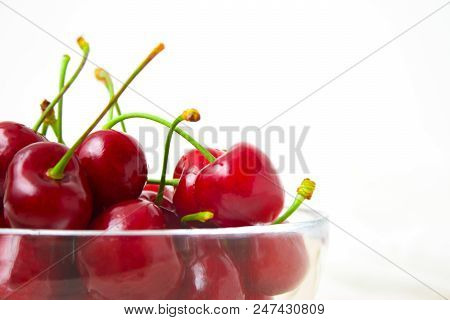 Healthy Eating And Food Concept - Cherries In Glass Dish. Cherry On Wood And White Background. Close