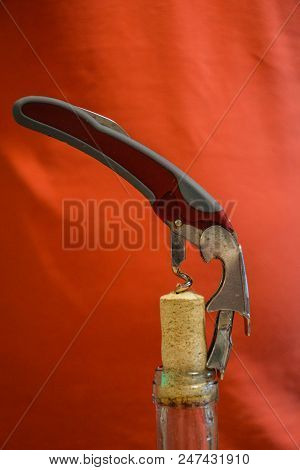 Opener Vine Close-up.corkscrew And Bottle Of Vine On The Board.bottle Of Wine With Corkscrew.setting