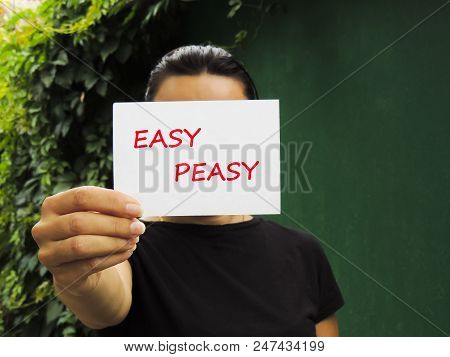 Easy Peasy. Message On The Card Shown By A Woman.