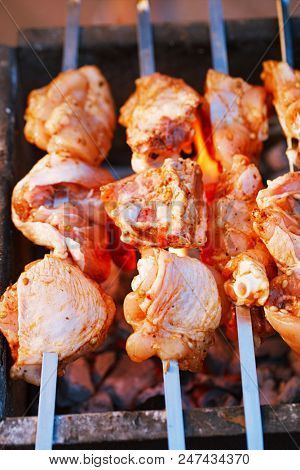 raw chicken kebab shashlik on skewers  and grii with flame