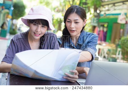 Portrait Of Happy Traveler Woman In City. Asian Women Using Map And Laptop For Seach Location, Peopl