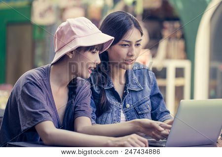 Portrait Of Happy Traveler Woman In City. Asian Women Using Laptop For Seach Location, People With T