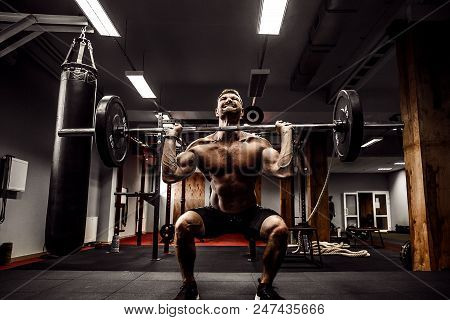 Muscular Fitness Man Doing Deadlift A Barbell Over His Head In Modern Fitness Center. Functional Tra
