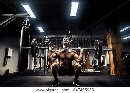 Muscular Strong Fitness Man Doing Deadlift Of A Barbell In Modern Fitness Center. Functional Trainin