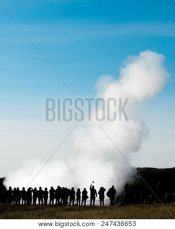 Silhouetted Crowd Of Tourists Watching Eruption Of Famous Torism Attraction Geyser Strokkur Dwarfed 