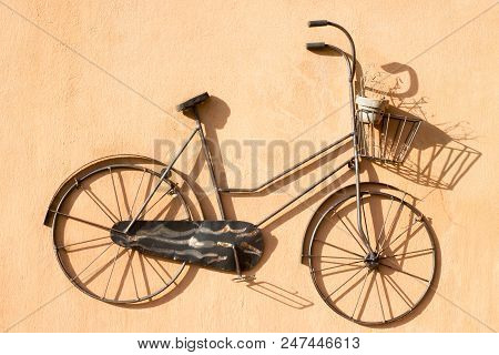 Old Bicycle On A Wall Of House