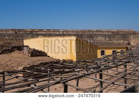View On The Area Of Castro Marim Castle, With Yellow Painted Buildings, Surrounded By Fortification 